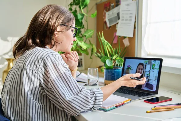 Business woman making video chat with client, partner in home office. Online meeting, video conference call, remote work, freelancing, female colleague on laptop screen. Tele technology, work business