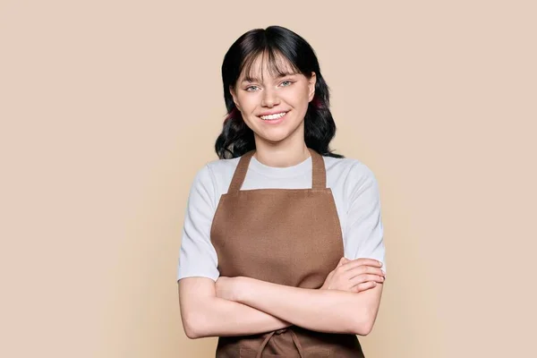Smiling Confident Young Woman Staff Apron Looking Camera Brown Color — Φωτογραφία Αρχείου