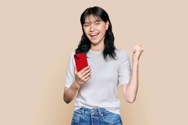 Portrait Enthusiastic Young Happy Emotional Student Girl Smartphone Raising Fist —  Fotos de Stock