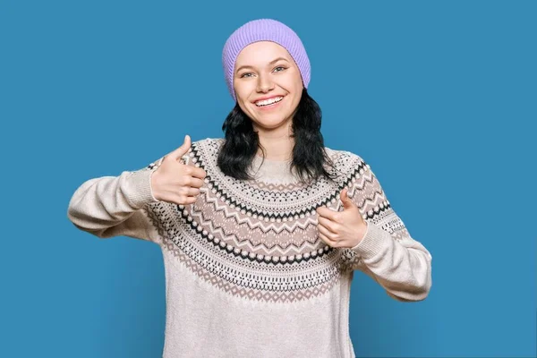 Happy Young Woman Sweater Hat Showing Thumbs Light Blue Background — Stockfoto