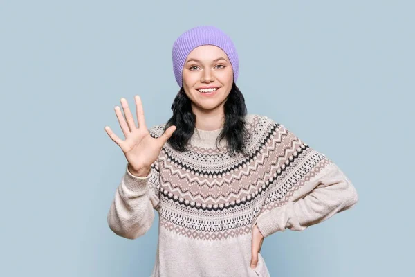 Friendly Cheerful Teenage Girl Winter Hat Sweater Waves Hand Camera — Stock fotografie