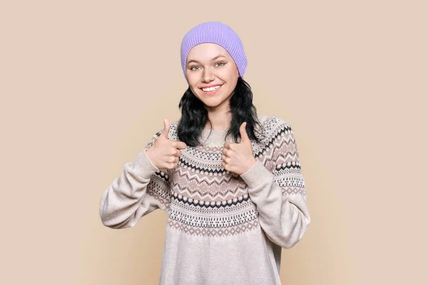 Happy Young Woman Sweater Hat Showing Thumbs Light Brown Background — Stock fotografie