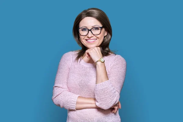 Attractive Confident Middle Aged Woman Looking Camera Blue Color Background — Stockfoto