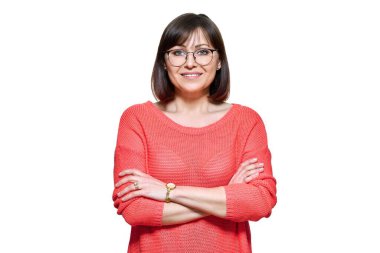 Attractive middle aged woman looking at camera on white isolated background. Smiling confident 40s female with glasses, crossed arms in red casual clothes. Lifestyle confidence calmness mature people