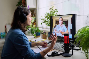 Online consultation of male student teenager in headphones by social worker, psychologist, behavior, teacher. Education, individual lessons, webinar, virtual meetings, modern technology concept