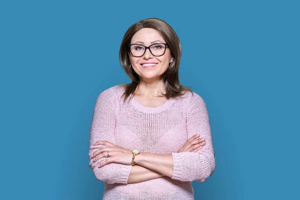 Attractive Confident Middle Aged Woman Looking Camera Blue Color Background —  Fotos de Stock