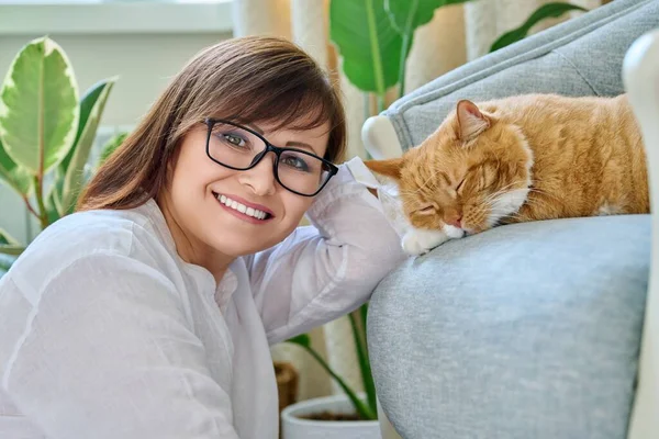 Portrait Smiling 40S Woman Pet Ginger Cat Lying Armchair Home — Stockfoto