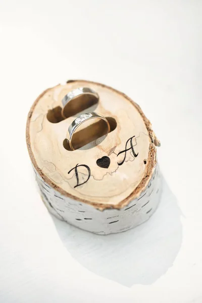Anneaux de mariage dans une boîte en bois de bouleau avec initiales. — Photo