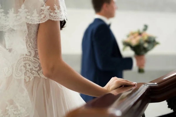 The bride goes to meet the groom. hand on a wooden railing close up. Stock Image