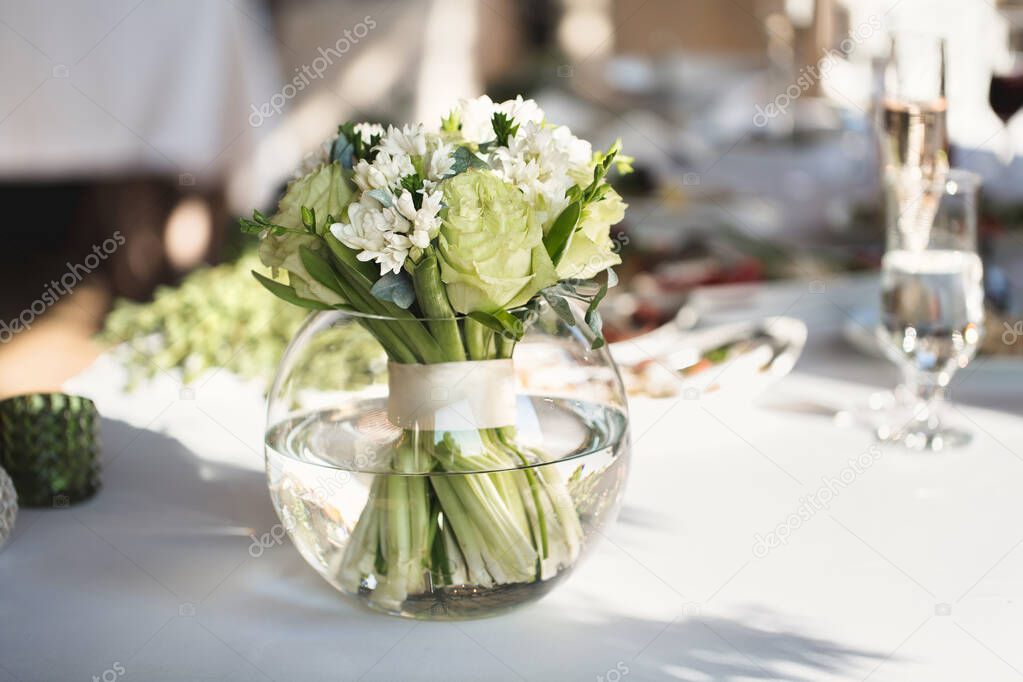 Table setting at a luxury wedding reception. Beautiful flowers on the table