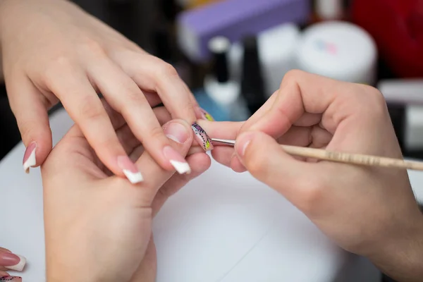 Closeup shot man making manicure to woman in beauty salon. — Stock Photo, Image