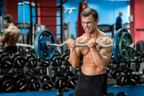 Very power athletic guy standing workout in the gym. — Stock Photo, Image