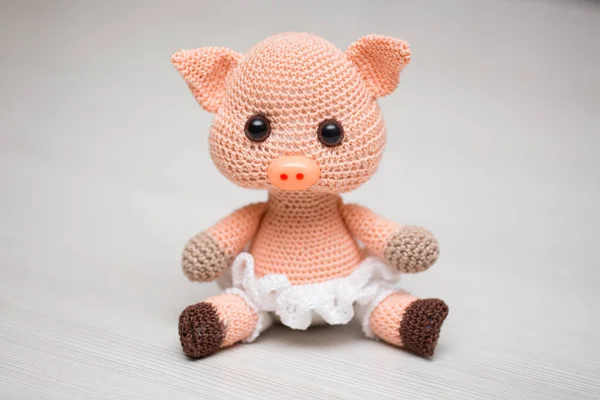 Un giocattolo di maiale lavorato a maglia per un bambino. Simbolo del nuovo anno. — Foto Stock