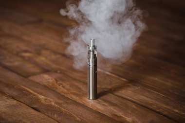 Tahta bir masada elektronik sigara. İç.