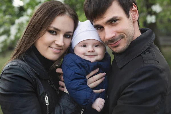 Mooie glimlachende gezichten van mensen. Een gelukkig jong gezin van drie personen. — Stockfoto
