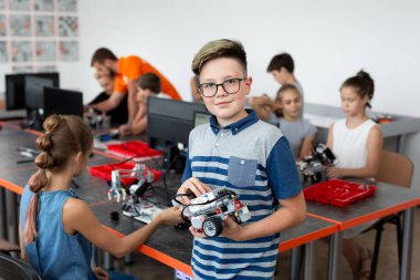 Okul Sonrası Bilgisayar Kodlama Sınıfında Erkek Öğrenci Bina Robot Araç Portresi.