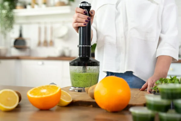 Close-up of the blender process. Im making a green smoothie with whitgrass. Mixing in a blender bowl — Stock Photo, Image
