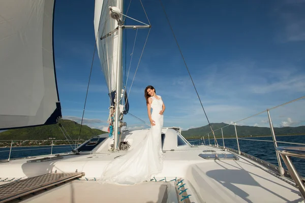 Щаслива наречена на яхті. Біла яхта з вітрильним набором йде вздовж острова . — стокове фото