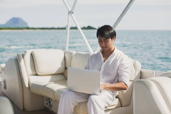 Businessman working with computer on a boat, nice outdoor office. — Stock Photo, Image