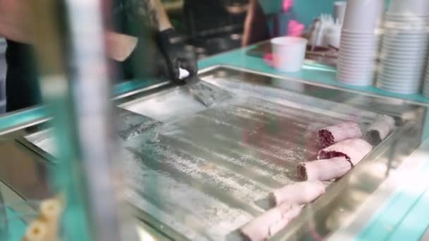 Stir-fried ice cream rolls at freeze pan. Rolled ice cream, hand made ice cream dessert. Fried ice cream machine with steel chilled pan — Stock Video