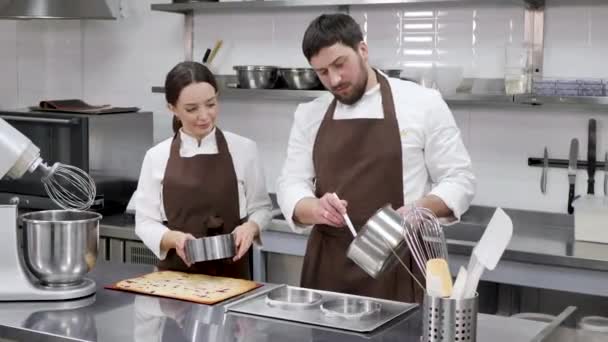 Femme et un homme confiseurs préparent remplissage de baies pour gâteau mousse — Video
