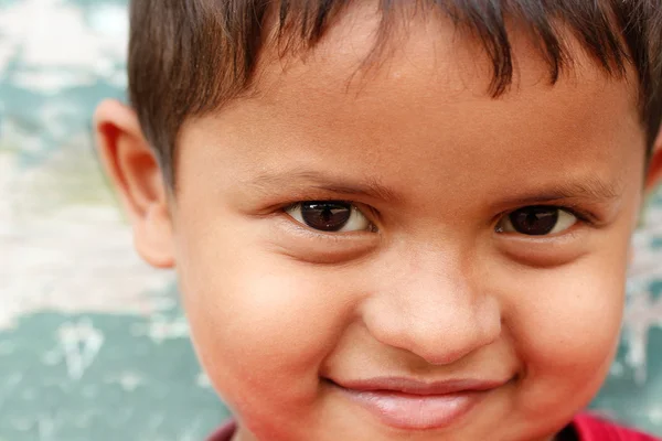 Closeup photo of a smiling and cute young asian/indian boy looki Stock Picture