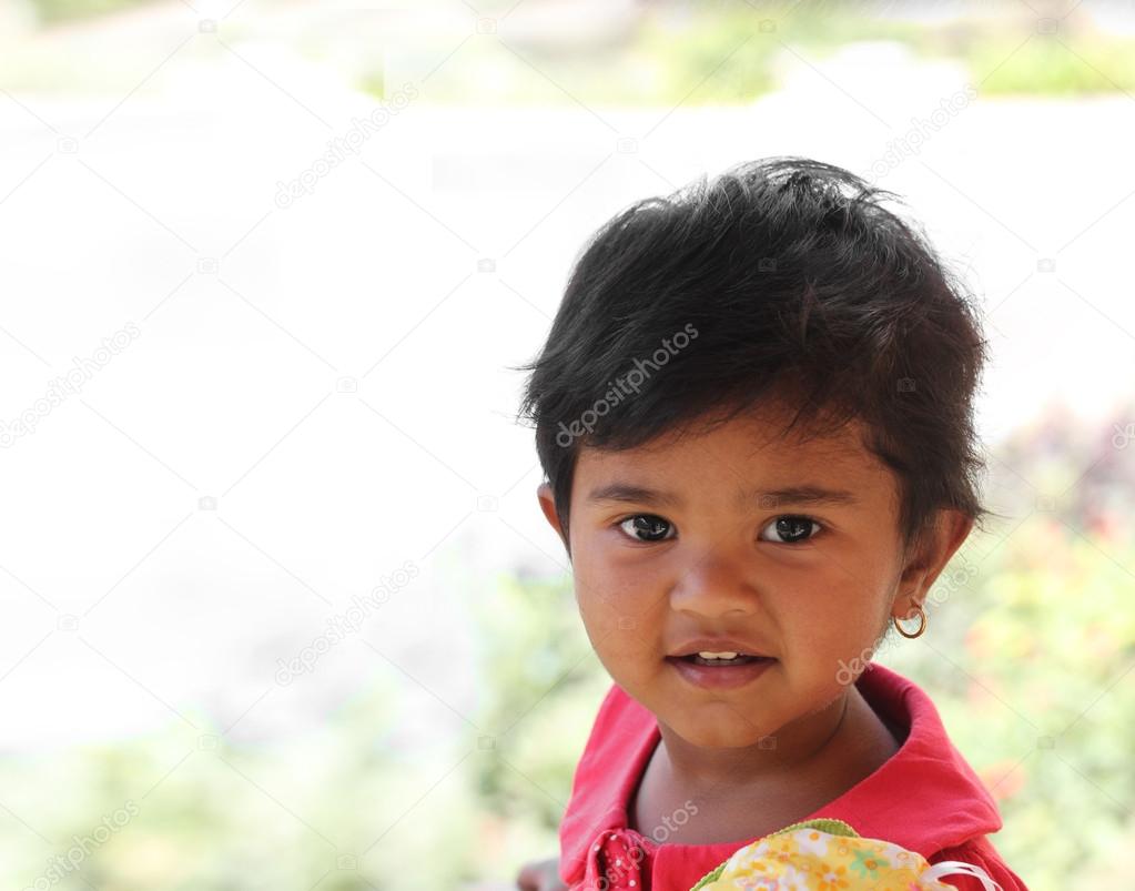 Photo of pretty and happy indian girl child with curious but sat