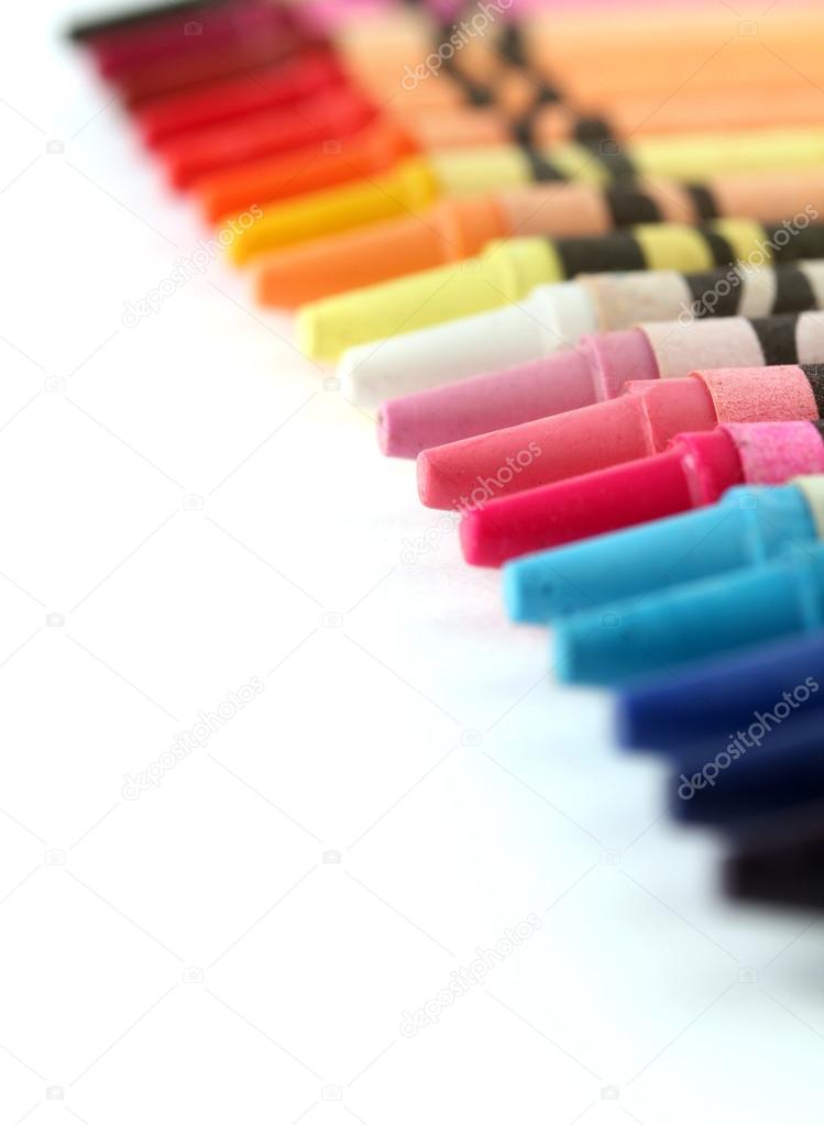 Beautiful colorful pastel(crayon) pencils in a row(line) on whit
