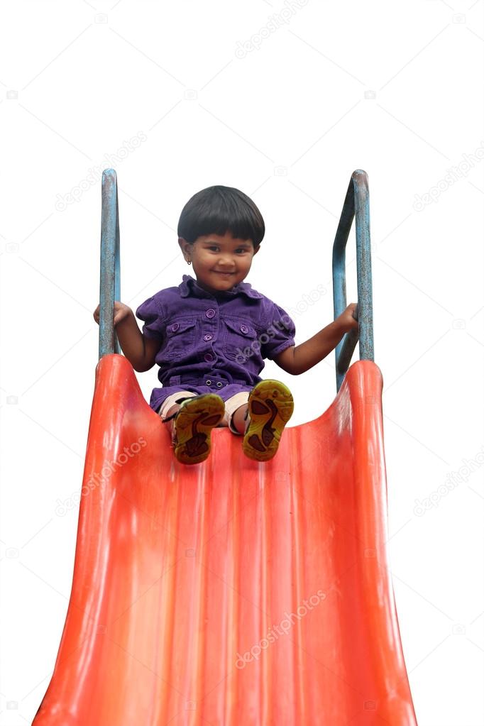 Beautiful cheerful(happy) indian girl(kid) on slider in a summer