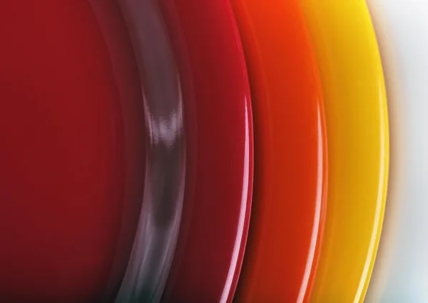 Orange, yellow and red colored plates stacked upon each other