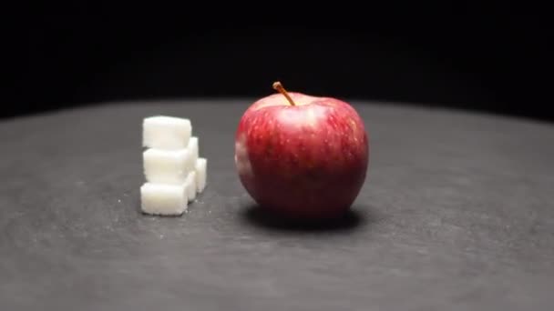 Soczyste owoce jabłkowe i stos cukru ryżowego na szarym stole — Wideo stockowe
