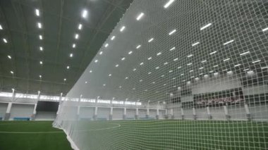 Net divides field with green covering in sports complex