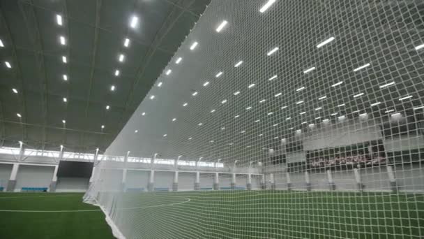 Net divides field with green covering in sports complex — Stock videók