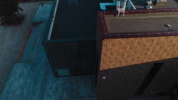 Multistory buildings with flat roofs in city at sunset light — Stockvideo