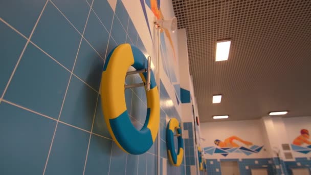 Lifesavers hang in hallway of pool for junior sportsmen — Wideo stockowe