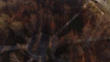 Playground and paved roads in small city park in autumn