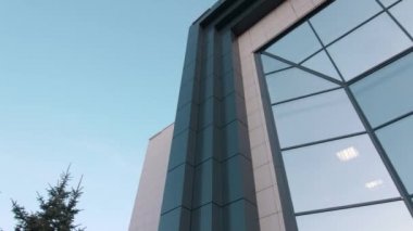 Motion to stylish office building with glass facade closeup