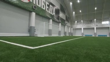 Word Victory on wall above football field in sports complex