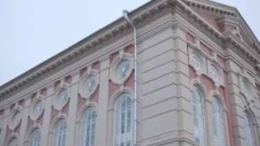 Historical public building with stylish windows on street