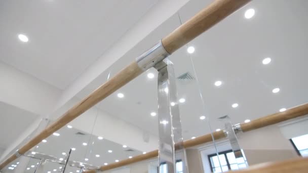 Wooden bars fastened to mirrors on wall in dance classroom — ストック動画