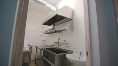Contemporary crockery washing room with large metal sinks