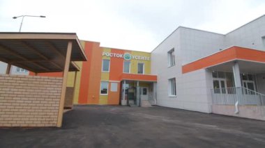 Motion to building with word Sprout on facade and neat porch