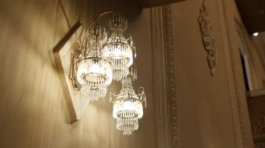 Chandelier on wall with vintage decor in auditorium hall