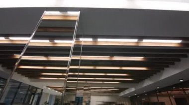 Glowing lamps on ceiling and mirror columns in concert hall