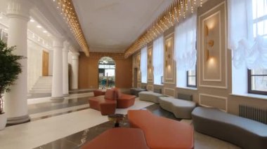 Comfortable sofas fairy lights and columns in palace hallway