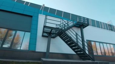 Metal staircases on wall of stylish building on city street