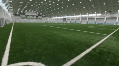 Court for football training and word Victory in large hangar