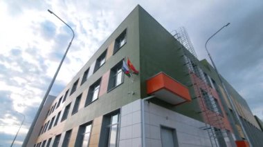 Building with national flags and bins for trash sorting