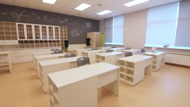 Classroom of sewing study group with desks and mannequins — Stockvideo