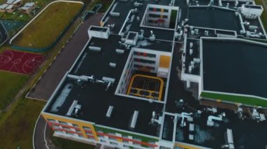 Building of kindergarten with playground in inner yard